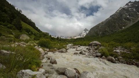 Movement of clouds and water flows in a stormy river in the mountains Video stock 86995087