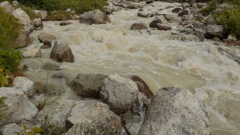 Movement of clouds and water flows in a stormy river in the Caucasus mountais Video stock 86995112