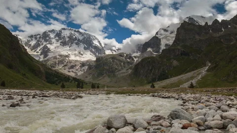 Movement of clouds and water flows in a stormy river in the Caucasus mountais Video stock 86995185