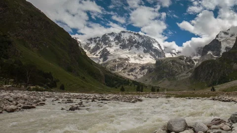 Movement of clouds and water flows in a stormy river in the Caucasus mountais Video stock 86995232