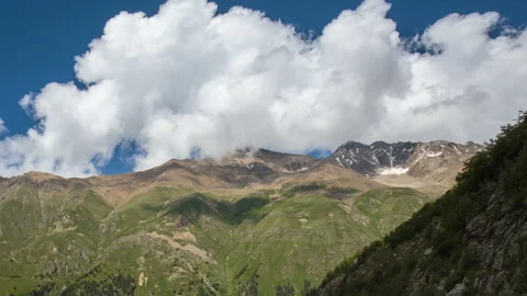 Movement of clouds and water flows in a stormy river in the Caucasus mountais Video stock 87296900