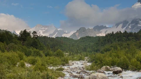 Movement of clouds and water flows in a stormy river in the mountains Video stock 87301362