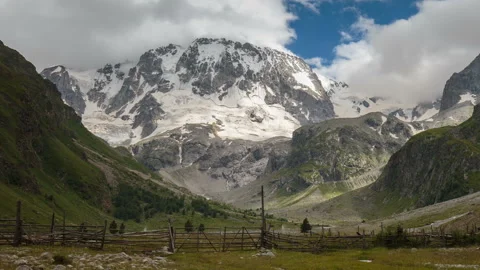 Movement of clouds and water flows in a stormy river in the Caucasus mountais Video stock 87301438