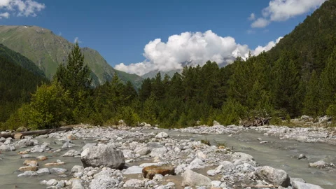 Movement of clouds and water flows in a stormy river in the Caucasus mountais Video stock 87345546