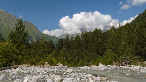 Movement of clouds and water flows in a stormy river in the Caucasus mountais Video stock 87346006