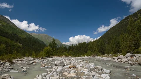 Movement of clouds and water flows in a stormy river in the mountains Stock Footage 87346299