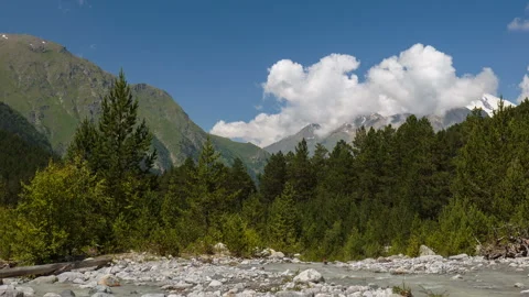 Movement of clouds and water flows in a stormy river in the Caucasus mountais Video stock 87346780
