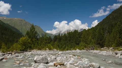 Movement of clouds and water flows in a stormy river in the mountains Stock Footage 87347454