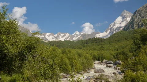 Movement of clouds and water flows in a stormy river in the Caucasus mountais Stock Footage 87349113