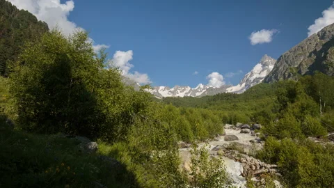 Movement of clouds and water flows in a stormy river in the mountains Stock Footage 87349440