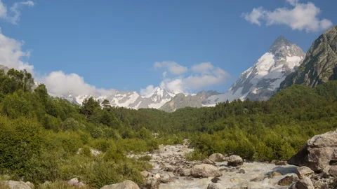 Movement of clouds and water flows in a stormy river in the Caucasus mountais Stock Footage 87349558