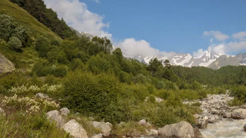 Movement of clouds and water flows in a stormy river in the Caucasus mountais Stock Footage 87349781