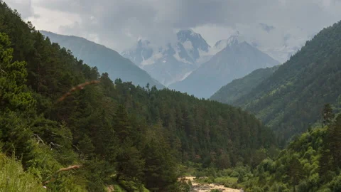 Movement of clouds and water flows in a stormy river in the Caucasus mountais Stock Footage 87349946