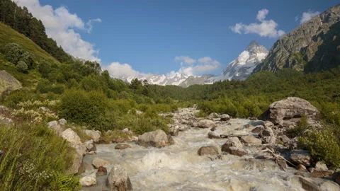 Movement of clouds and water flows in a stormy river in the mountains Stock Footage 87349963
