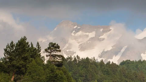 Movement of clouds and water flows in a stormy river in the Caucasus mountais Stock Footage 87350296