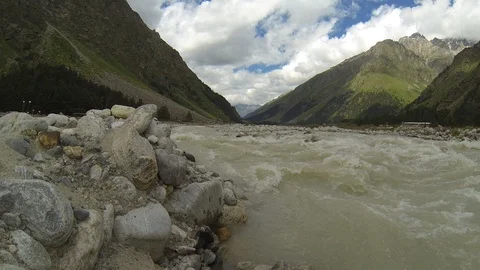 Movement of clouds and water flows in a stormy river in the Caucasus mountains Video stock 87533401