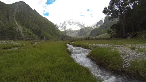 Movement of clouds and water flows in a stormy river in the Caucasus mountains Stock Footage 87533604
