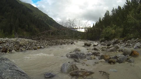 Movement of clouds and water flows in a stormy river in the Caucasus mountains Video stock 87533787