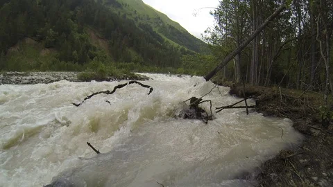 Movement of clouds and water flows in a stormy river in the Caucasus mountains Stock Footage 87534091