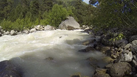 Movement of clouds and water flows in a stormy river in the Caucasus mountains Video stock 87534883