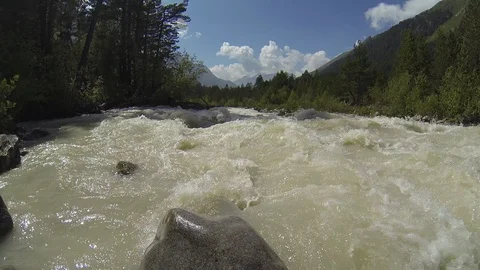 Movement of clouds and water flows in a stormy river in the Caucasus mountains Stock Footage 87535413