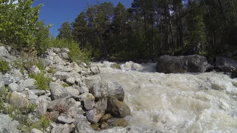 Movement of clouds and water flows in a stormy river in the Caucasus mountains Stock Footage 87535854
