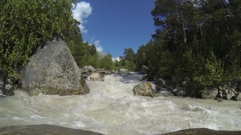 Movement of clouds and water flows in a stormy river in the Caucasus mountains Stock Footage 87535877