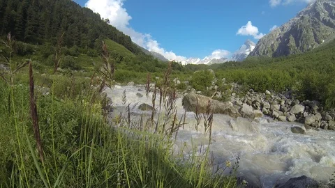 Movement of clouds and water flows in a stormy river in the Caucasus mountains Stock Footage 87535977