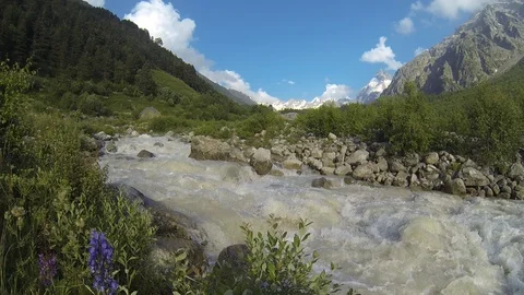 Movement of clouds and water flows in a stormy river in the Caucasus mountains Stock Footage 87536114