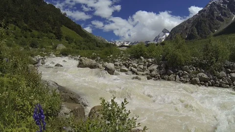 Movement of clouds and water flows in a stormy river in the Caucasus mountains Video stock 87536259
