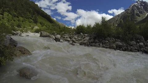 Movement of clouds and water flows in a stormy river in the Caucasus mountains Stock Footage 87536316