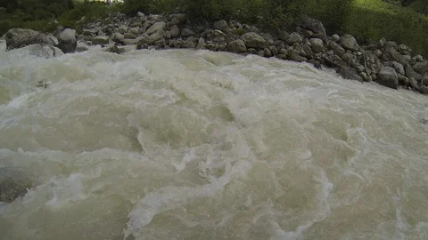 Movement of clouds and water flows in a stormy river in the Caucasus mountains Video stock 87536384