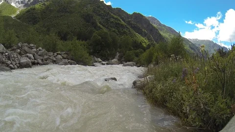 Movement of clouds and water flows in a stormy river in the Caucasus mountains Stock Footage 87536389