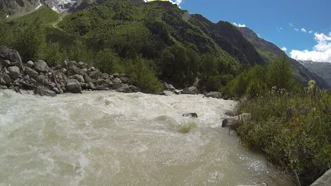 Movement of clouds and water flows in a stormy river in the Caucasus mountains Stock Footage 87536403