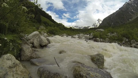 Movement of clouds and water flows in a stormy river in the Caucasus mountains Stock Footage 87536453