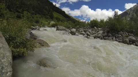 Movement of clouds and water flows in a stormy river in the Caucasus mountains Video stock 87536460
