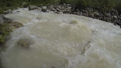 Movement of clouds and water flows in a stormy river in the Caucasus mountains Stock Footage 87536462