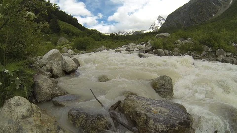 Movement of clouds and water flows in a stormy river in the Caucasus mountains Stock Footage 87536512