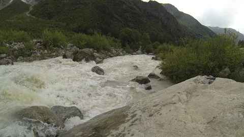 Movement of clouds and water flows in a stormy river in the Caucasus mountains Stock Footage 87536533
