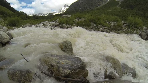 Movement of clouds and water flows in a stormy river in the Caucasus mountains Stock Footage 87536540