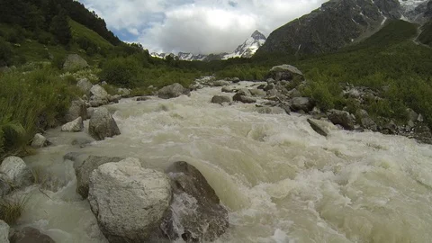Movement of clouds and water flows in a stormy river in the Caucasus mountains Stock Footage 87536615