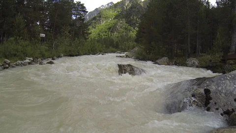 Movement of clouds and water flows in a stormy river in the Caucasus mountains Stock Footage 87536672
