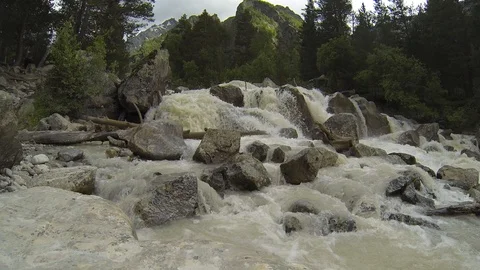 Movement of clouds and water flows in a stormy river in the Caucasus mountains Video stock 87536801