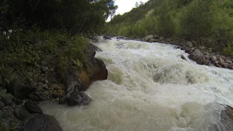 Movement of clouds and water flows in a stormy river in the Caucasus mountains Stock Footage 87536830