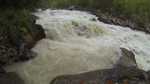 Movement of clouds and water flows in a stormy river in the Caucasus mountains Stock Footage 87536924
