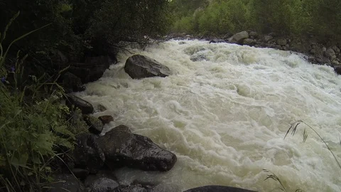 Movement of clouds and water flows in a stormy river in the Caucasus mountains Stock Footage 87536941