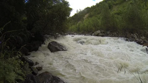 Movement of clouds and water flows in a stormy river in the Caucasus mountains Stock Footage 87536976