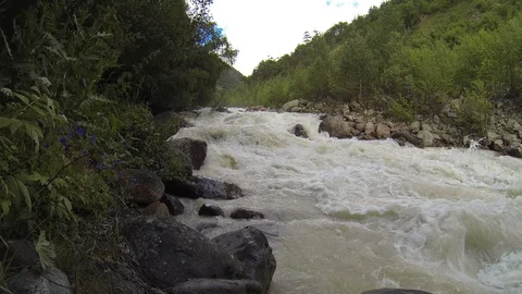Movement of clouds and water flows in a stormy river in the Caucasus mountains Stock Footage 87537003