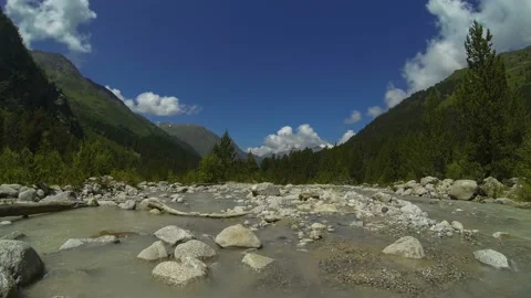 Movement of clouds and water flows in a stormy river in the Caucasus mountains Stock Footage 87616114