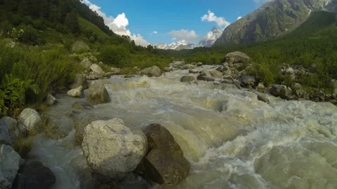 Movement of clouds and water flows in a stormy river in the Caucasus mountains Stock Footage 87617291
